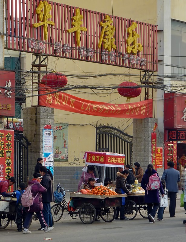 china street scene liquor store orange stand tofu kids with pink backpacks