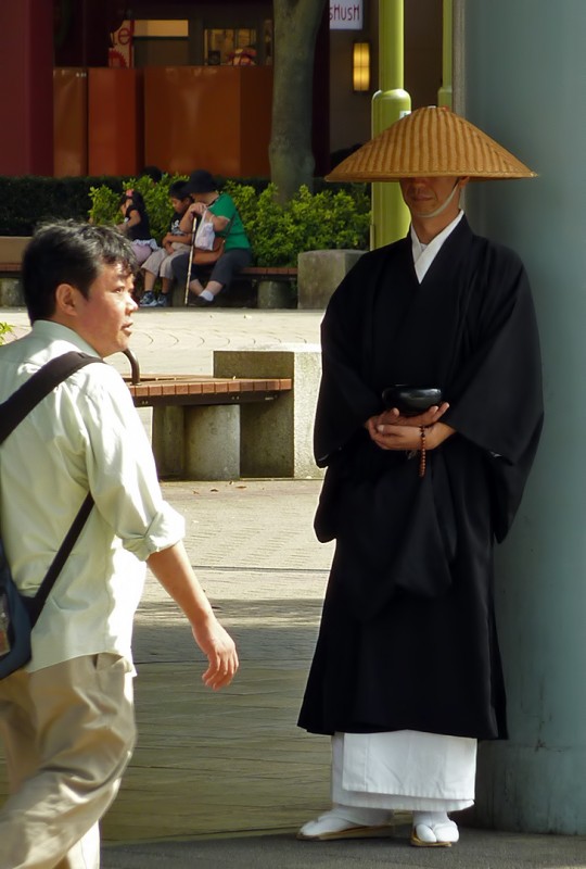 buddhist monk in japan begging for alms