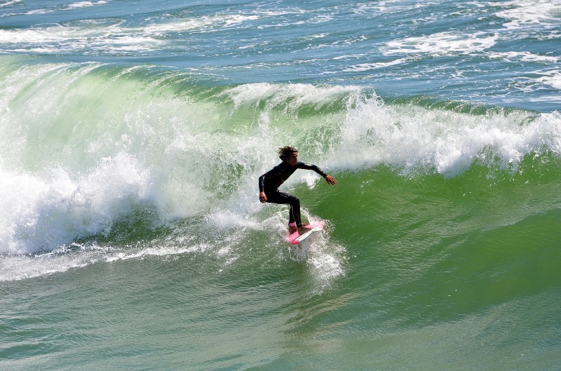 surfer surfing in huntington beach california